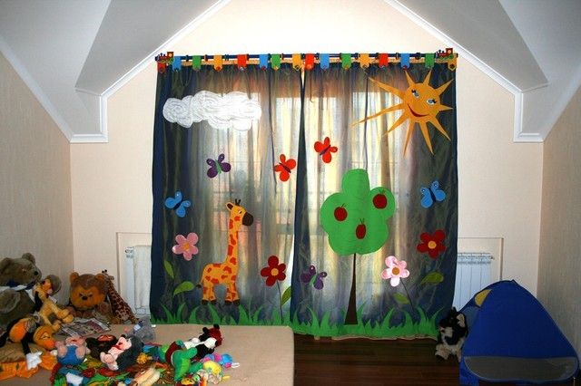 Curtains with colorful decoration in the nursery for the boy