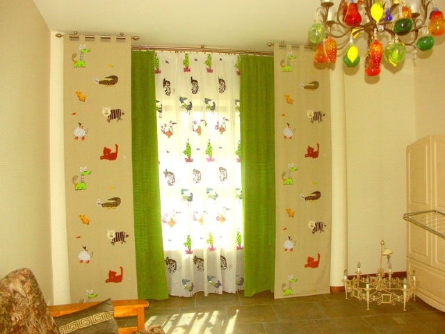 Curtains of light green color in the nursery for the boy
