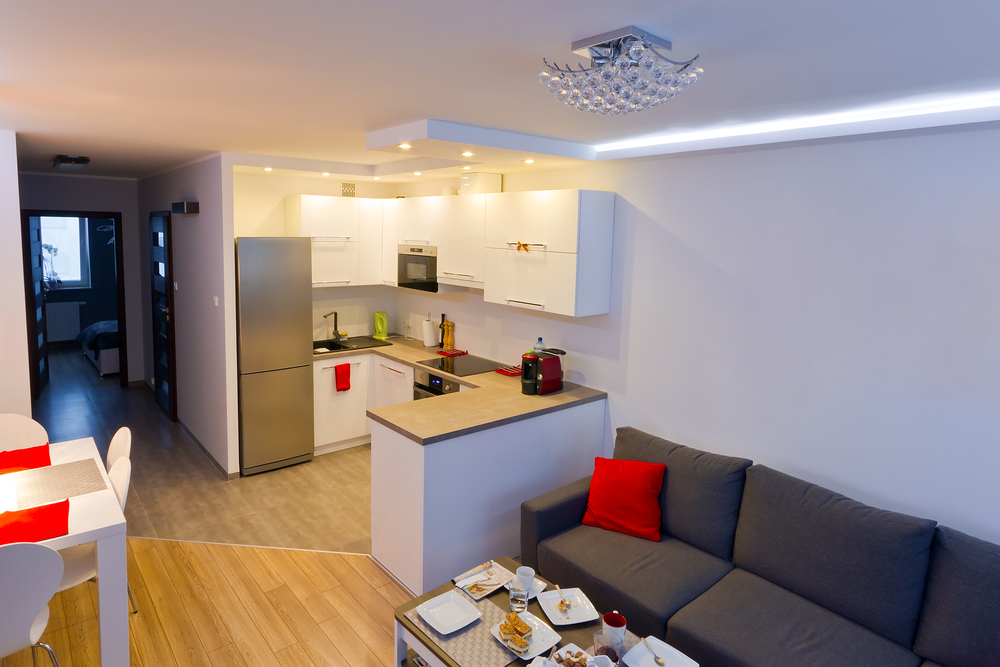 Photo of the unusual interior of the kitchen-living room with bright accents in the decor