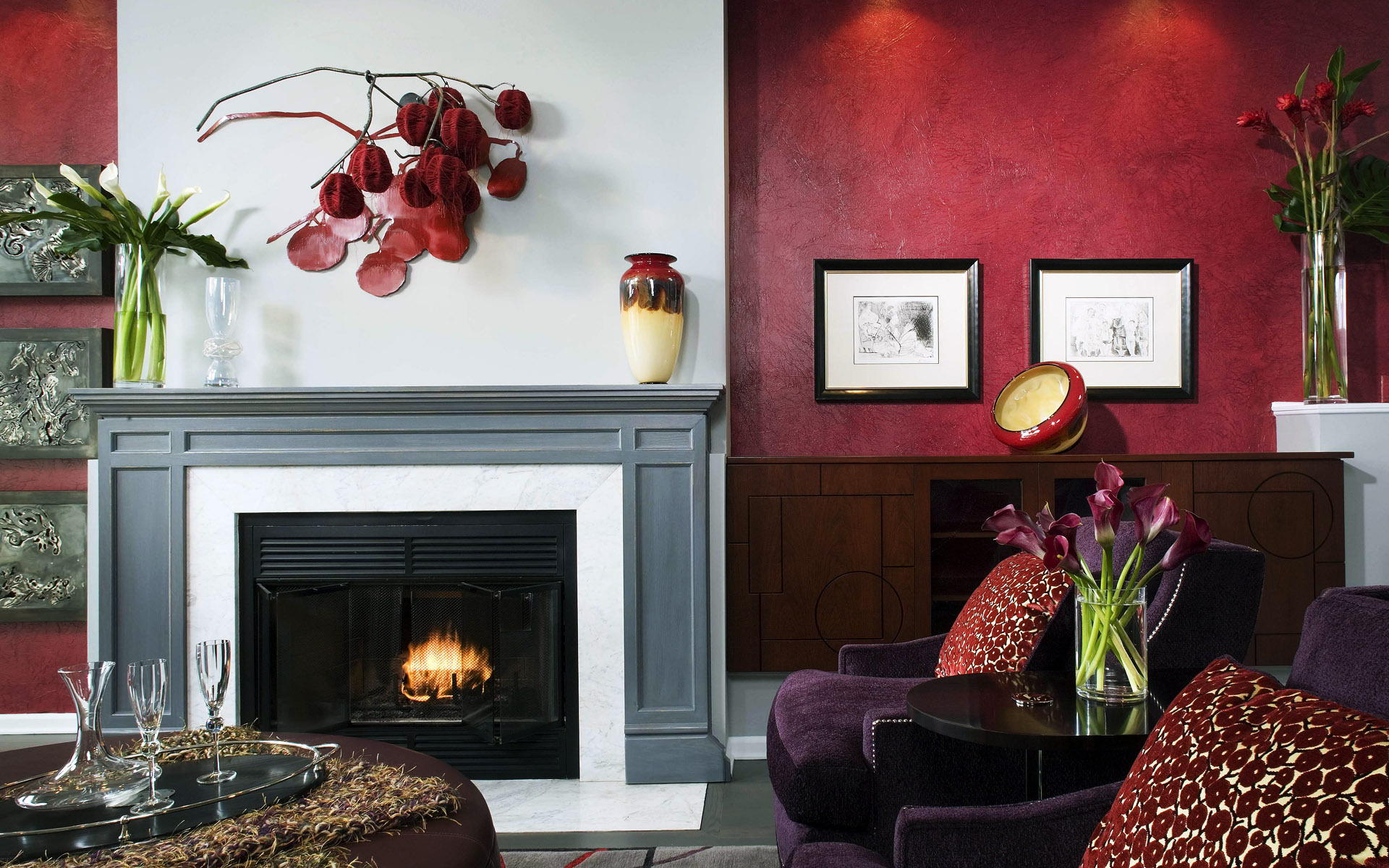 Fireplace for a stylish living room interior with red bright walls