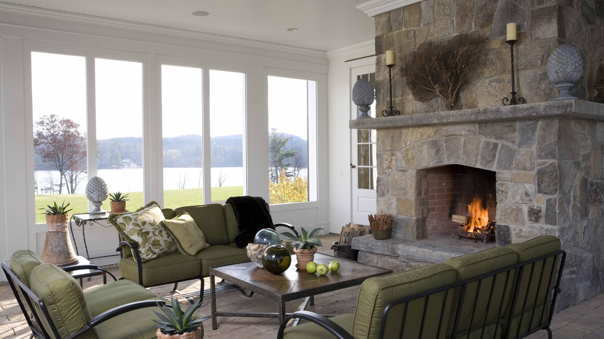 Spacious living room interior with stained-glass windows and fireplace.