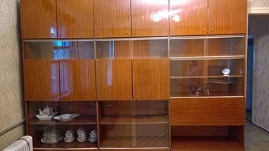 Showcase with wooden cupboards in the living room