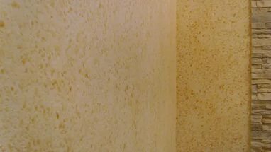 Sand-colored liquid wallpaper combined with stone trim