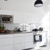 bright interior of a white kitchen with a touch of green picture