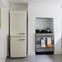 large refrigerator in the facade of the kitchen in gray photo