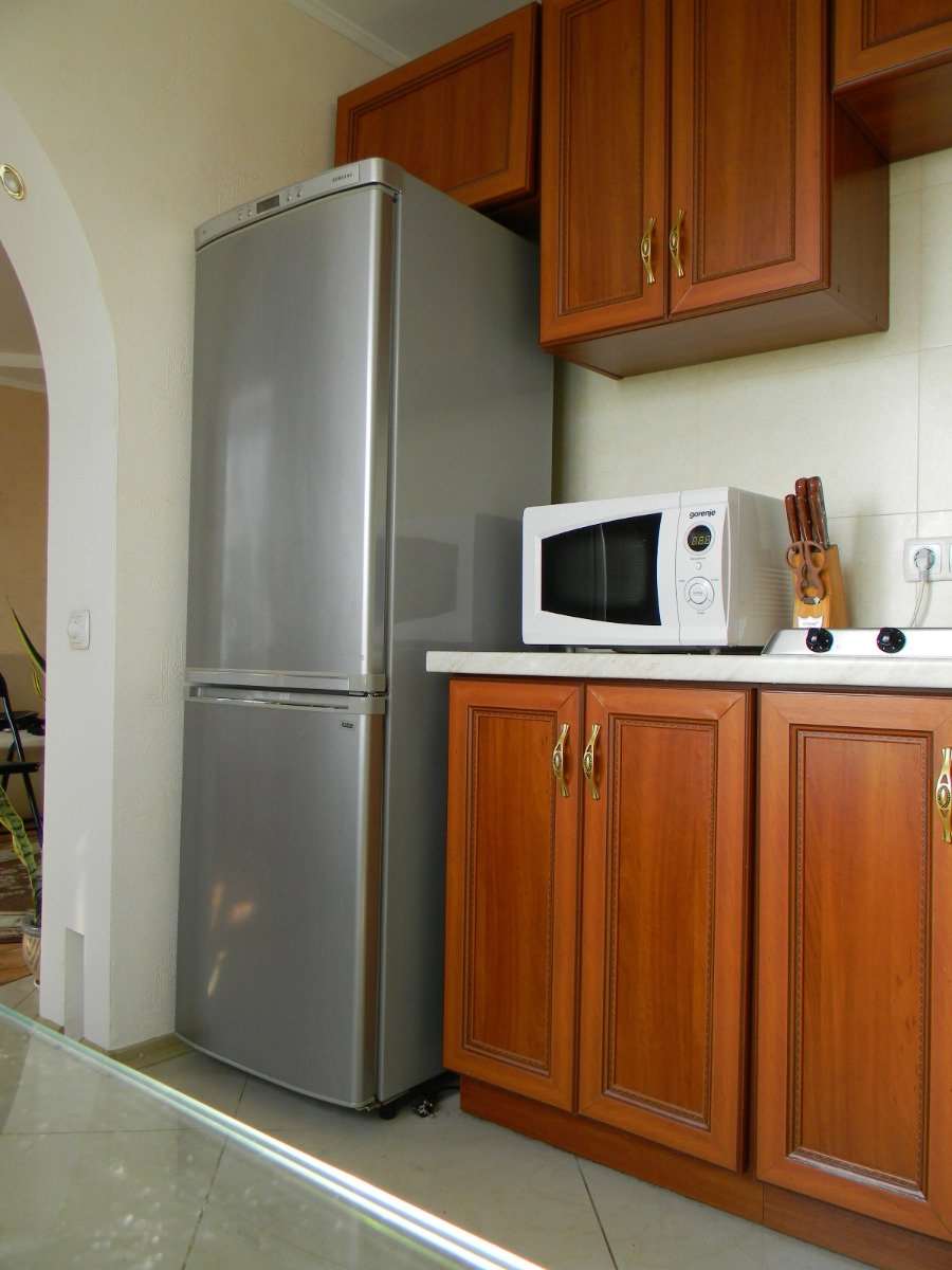 large refrigerator in the design of the kitchen in black
