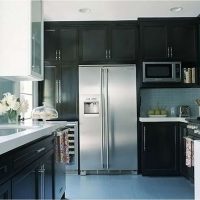 a small refrigerator in the facade of the kitchen in gray picture