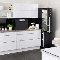 small refrigerator in the decor of the kitchen in a dark color photo