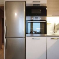 a large refrigerator in the interior of the kitchen in black photo