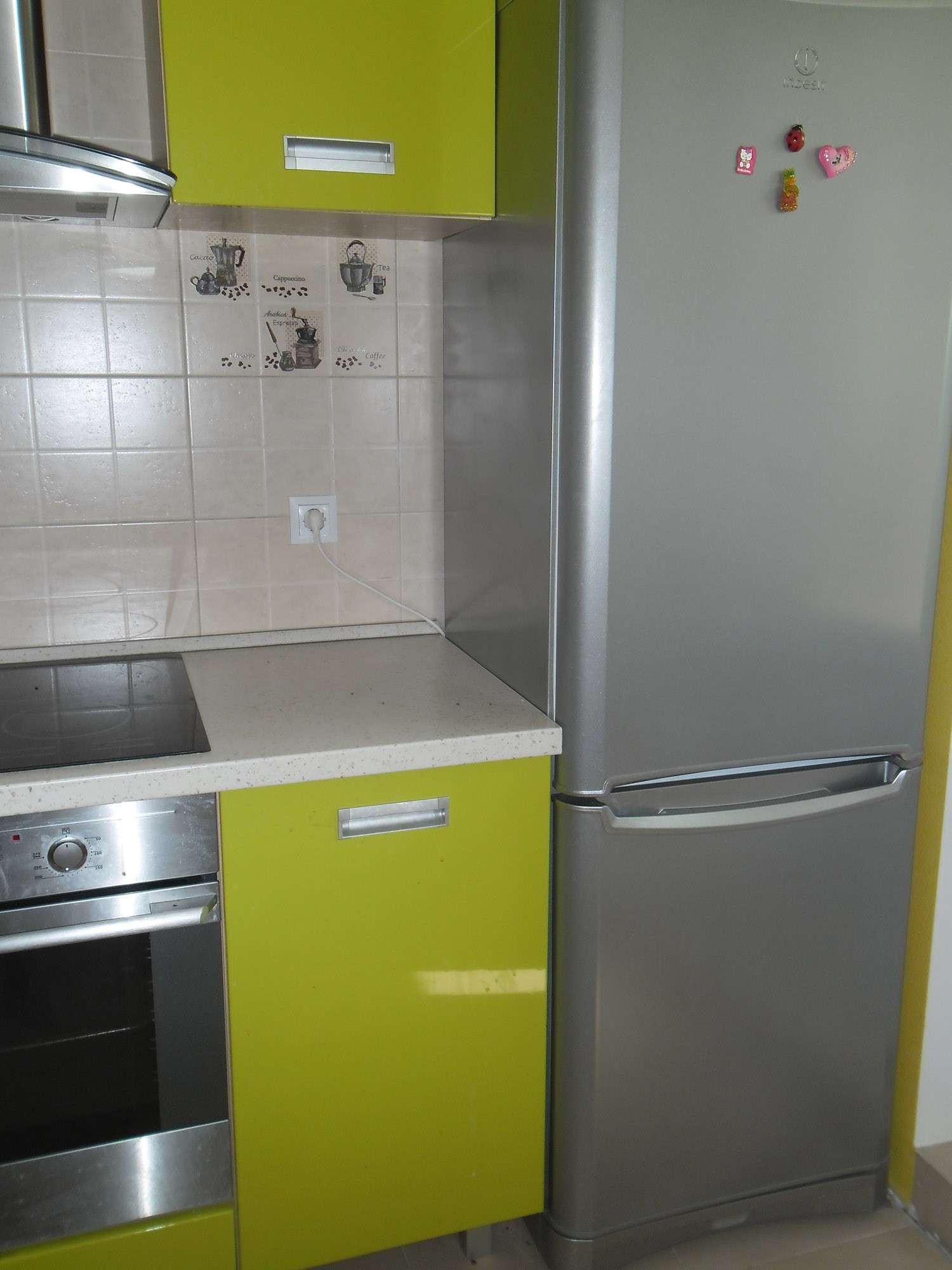 a large refrigerator in the facade of the kitchen in multi-colored