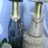 bright decoration of glass bottles with decorative ribbons picture