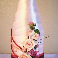 beautiful decoration of glass bottles with colorful ribbons photo