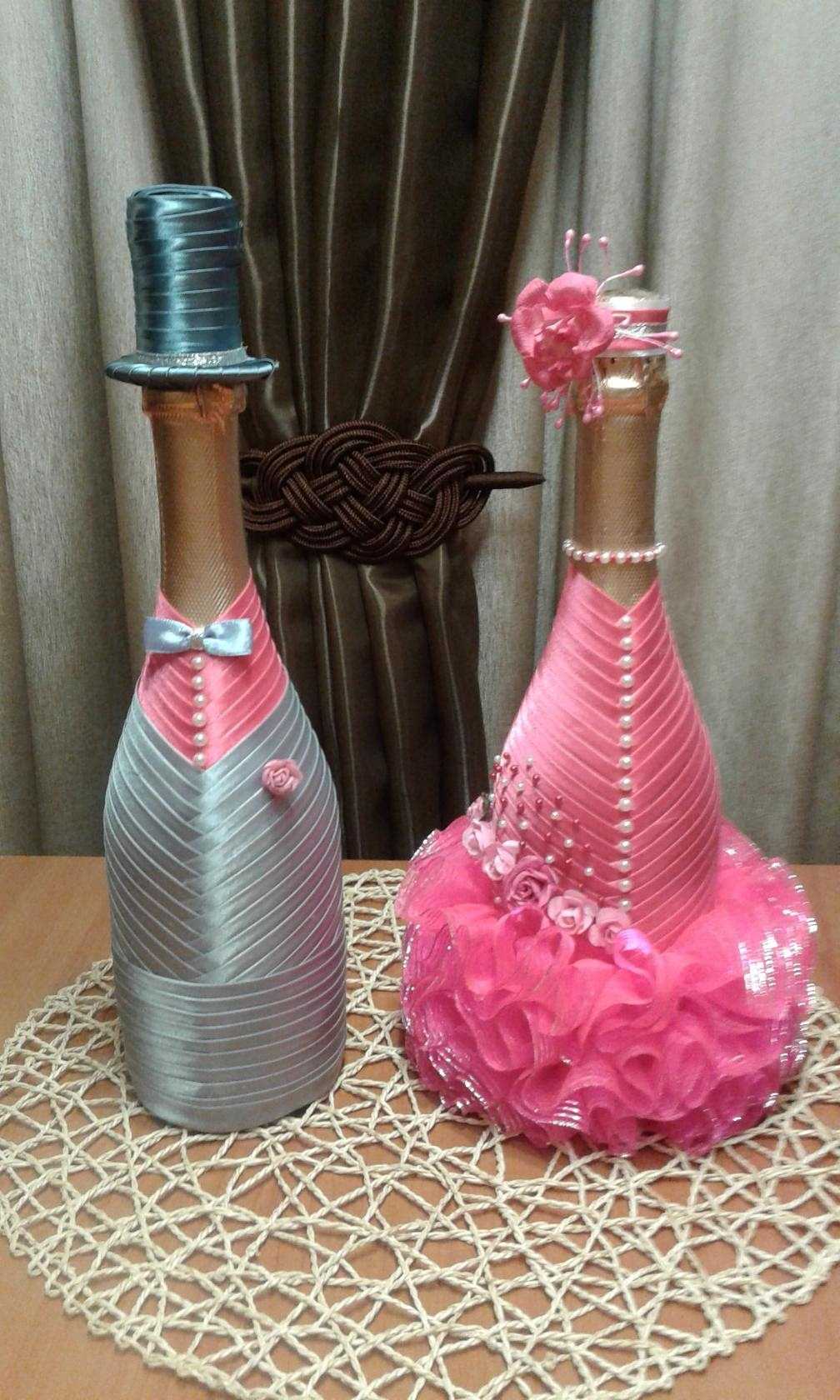 bright decoration of champagne bottles with colorful ribbons