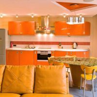 a combination of dark orange in the style of the kitchen with other colors of the photo
