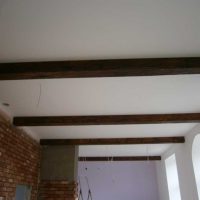 version of the bright decor of the apartment with decorative beams photo