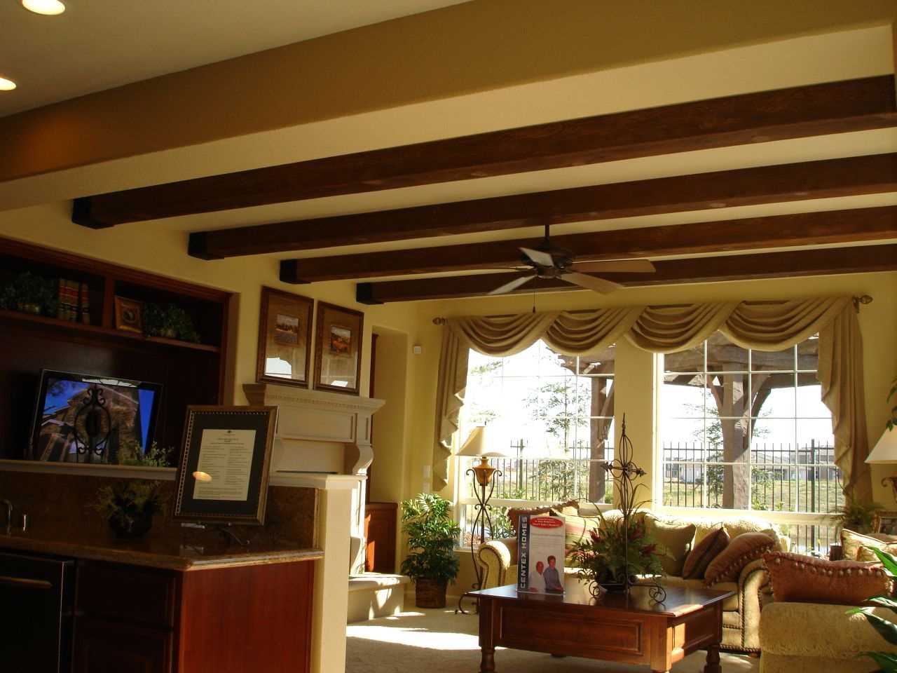 variant of the bright decor of the apartment with decorative beams