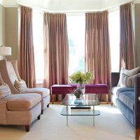 An example of a bright living room design with a bay window photo