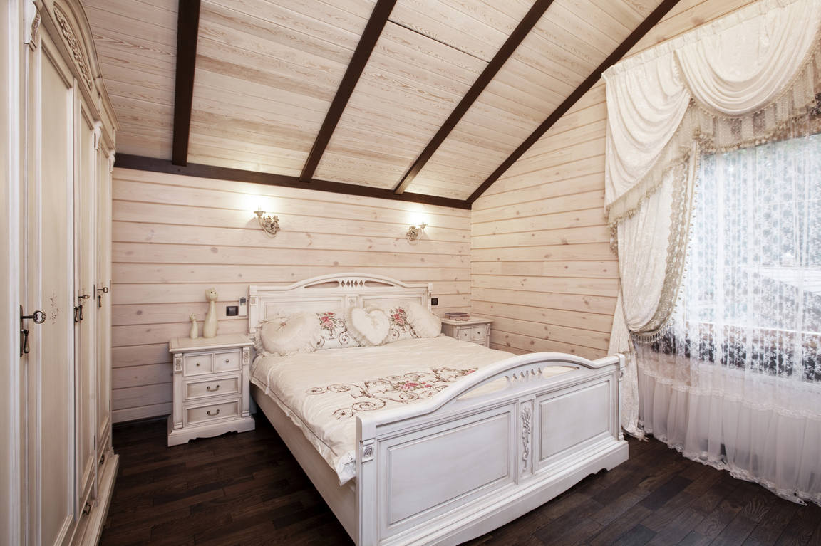 design of a bedroom in a wooden house