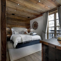 bedroom in a wooden house gray-brown colors