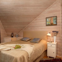 bedroom in a wooden house with beveled ceiling