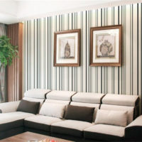 Striped wallpaper and paintings in the interior of the living room