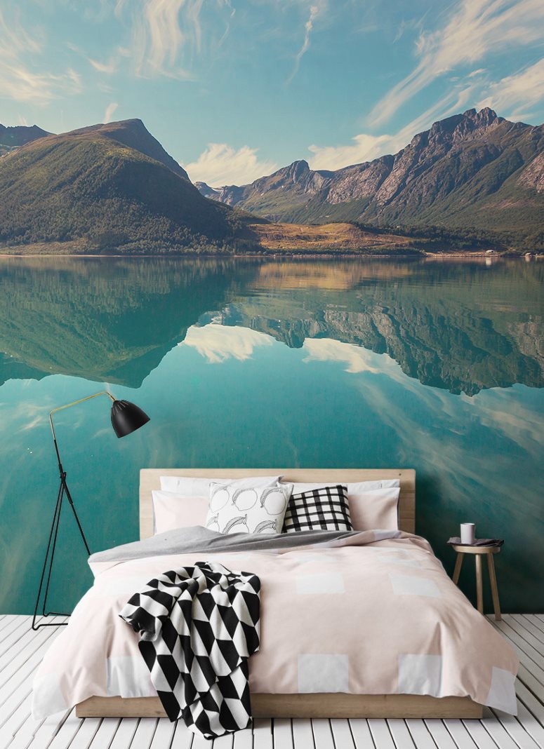 Mountains and lake on the mural in the bedroom interior