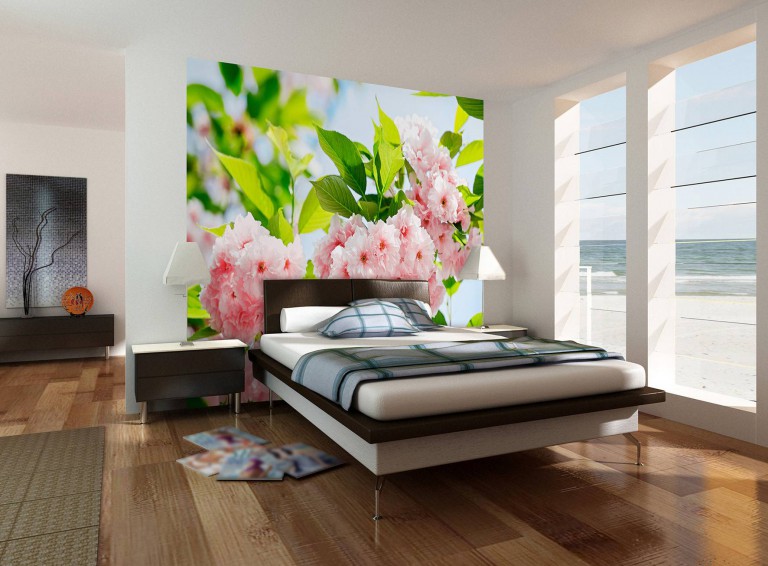 Wall mural with bright flowers and leaves in the design of the bedroom