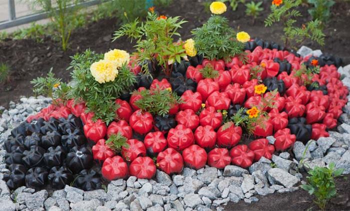 Garden flower bed made of plastic bottles