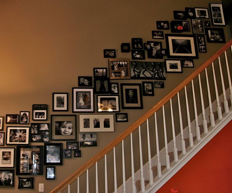 Collage of photos in the design of the wall above the stairs