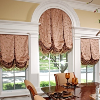 Roman curtains on the windows in a modern living room