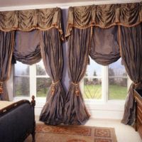 Beautiful curtains with lambrequins on the windows in the living room
