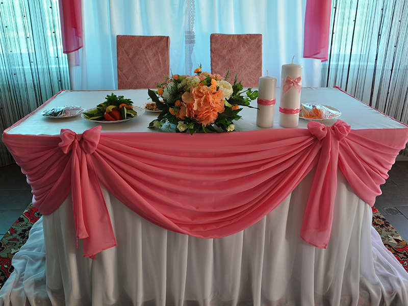 Pink tulle skirt on the wedding table of the newlyweds