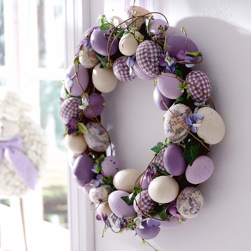 Easter wreath of colored eggs on the door of the house