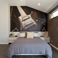 Wall mural with a guitar in the bedroom of a musician