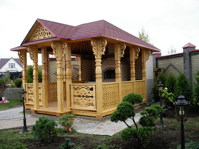 Beautiful design of a wooden arbor in the Russian style