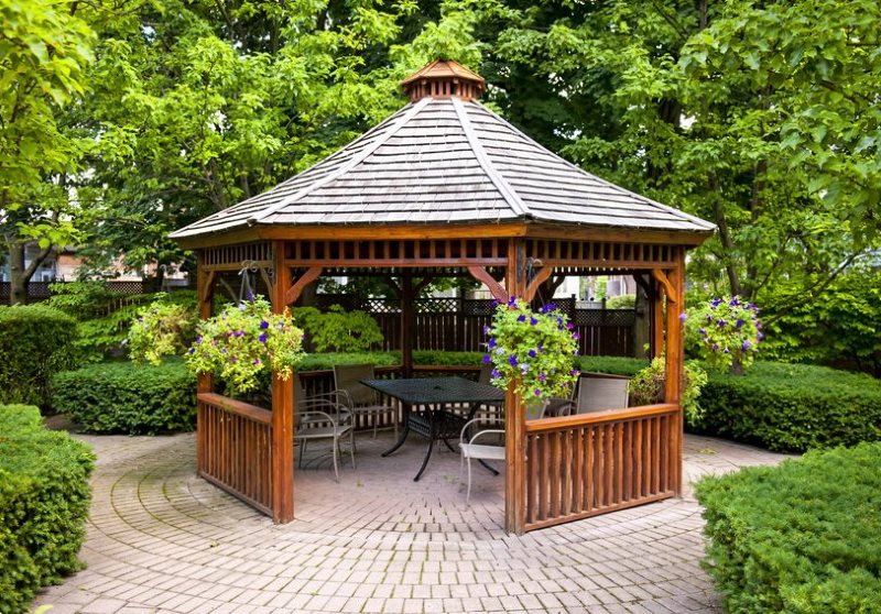 Arbor made of natural wood on a paved area