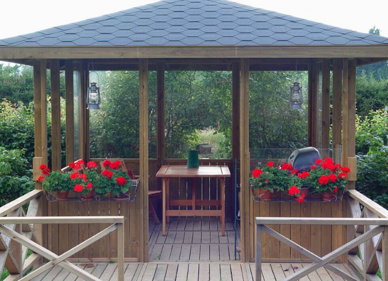 Decorating a wooden gazebo with flowers in containers