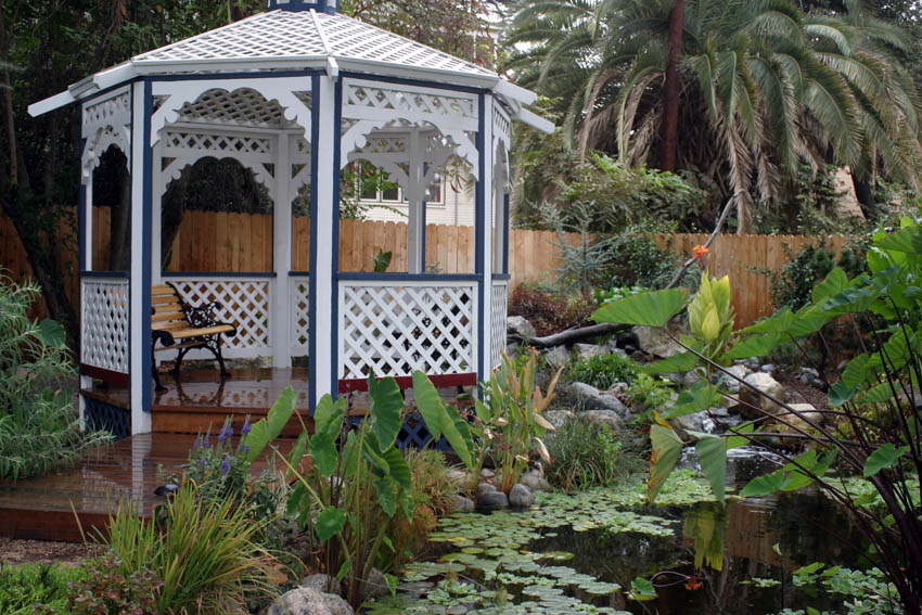 Wooden arbor and artificial pond in garden design