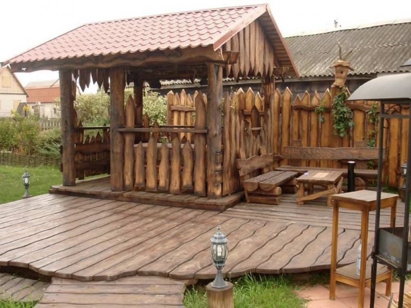 Country-style wooden gazebo with a platform made of larch boards