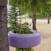 Hanging flowerbed from a tire for garden decoration