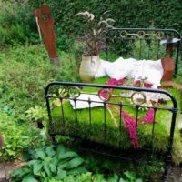Old bed in the decor of the garden