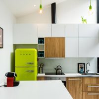 Light green refrigerator and wood-like facades in the kitchen