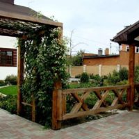 Pergola made of wood in front of the entrance to the garden