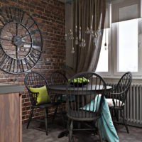 Clock on a brick wall in the loft style kitchen