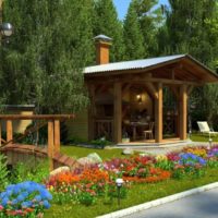Blooming flower bed in front of a wooden gazebo with fireplace