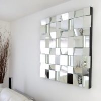 Mirror panel in the design of the wall in the living room