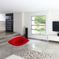 Red armchair in a white living room