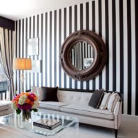 Mirror in the living room on the wall with striped wallpaper