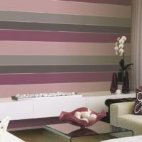 Interior of a living room with horizontal stripes on the wallpaper