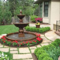 Beautiful fountain in front of the porch of a private house